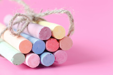 Color chalk crayon on pink background