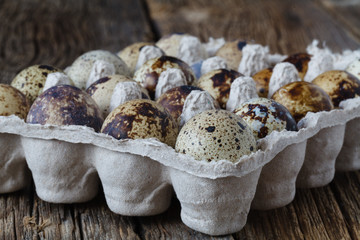 Organic quail eggs on rustic wooden table