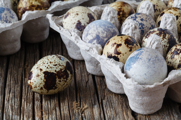 Quail eggs on old brown wooden surface