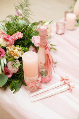 Details of decoration of Groom's and Bride's wedding table on wedding party. Decoration by pink fabric and flowers. Bonbonnieres with honey for guests