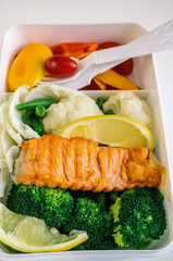 Lunch box with food on wooden background, top view