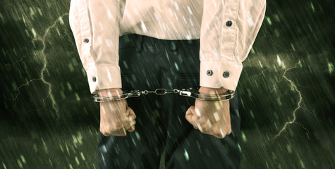 Stormy bad day concept with close handcuffed elegant man
