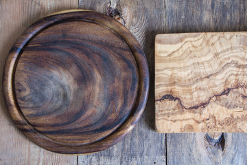 Chopping boards of different shapes on a wooden background. View from above.