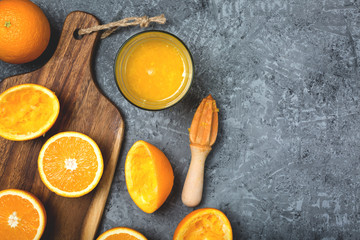 Fresh orange juice, slices of orange, against a dark background. Top view with a copy.