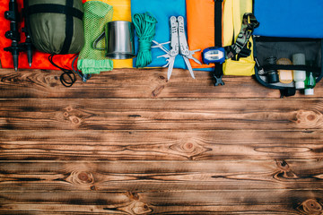 Top view of equipment for hiking and travel on Gray background with copy space . Items include...