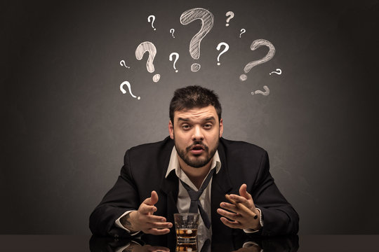 Young drunk disappointed man with question signs concept
