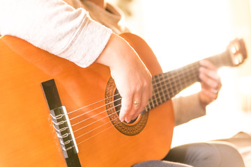 woman playing spanish guitar