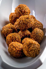 Falafel balls on a white background. Falafel is a traditional Middle Eastern food, commonly served in a pita.Vertical image.