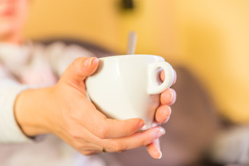 cup of coffee in woman's hands