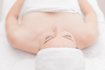 Fototapeta na wymiar Young woman relaxing at health spa massage