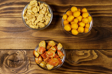 Mix of snacks for beer on wooden table