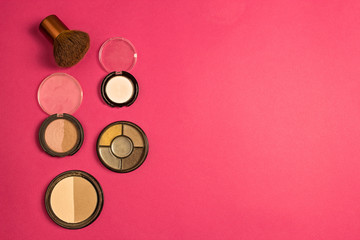 Set of cosmetics on a pink background