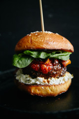 Burgers with grilled beef patties, cream cheese and spinach on classical bun.