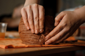 Woman's hand making clay pot on the pottery workplace. Ceramist modeling on pottery workshop. Close...