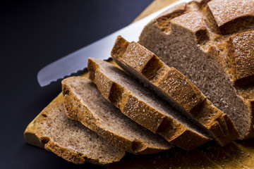 Sliced rye bread on cutting board closeup