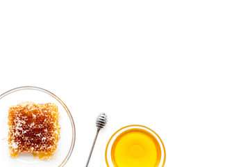 Apiary products. Honey in bowl and honeycomb on white background top view copy space