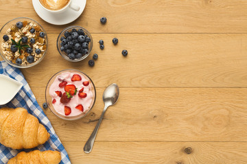 Continental breakfast with croissants and berries on natural woo