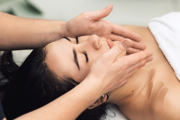 Fototapeta na wymiar Facial massage in spa. Cosmetology clinic, spa, wellness, health care concept.