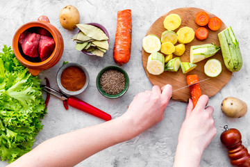 cut vegetables for cooking ragout or ratatouille for healthy dinner stone background top view