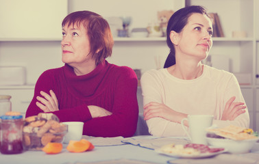Portrait of sad mature woman talking with daughter
