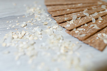 Close-up of dietary loaves laid out in the form of a fan on each other on a wooden table in rice flakes. Dry snacks dietary breakfasts, loaves on a grey wooden table.