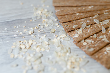 Close-up of dietary loaves laid out in the form of a fan on each other on a wooden table in rice flakes. Dry snacks dietary breakfasts, loaves on a grey wooden table.