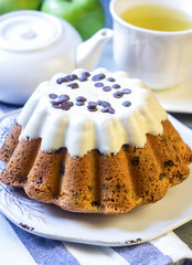 Glazed fresh cake on a round wooden stand