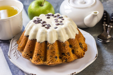 Glazed fresh cake on a round wooden stand