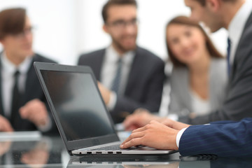Hands of business man working on laptop.
