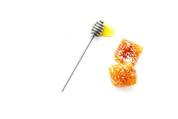 Honeycomb filled with honey on plate on white background top view space for text