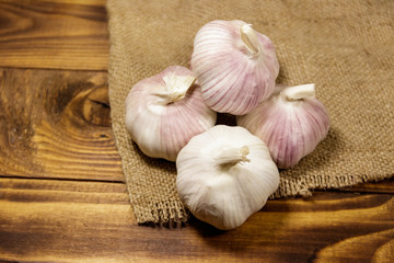 Bulbs of garlic on wooden table