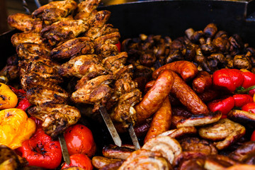 Street food shish kebab sausages and vegetables on the counter