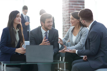 Beautiful business people are using gadgets, talking and smiling