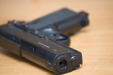 pistol on brown table close-up