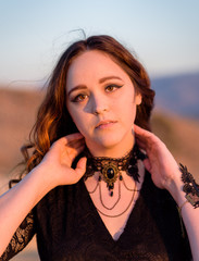 Brunette Female wearing lace dress in field