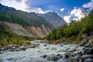 A lively mountain river in the spring. The Chalaadi Glacier. Svaneti. Georgia