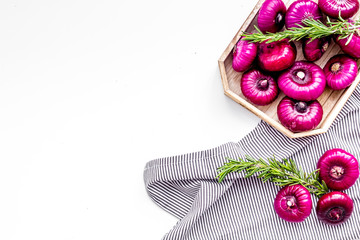 Red onion is healthy product. Onion bulbs in tray on white background top view space for text
