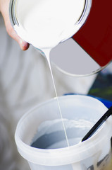 Mixing paints in a plastic container. Tinting paint.