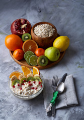 Breakfast still life with oatmeal porridge, fruits and coffee cup, top view, selective focus, shallow depth of field.