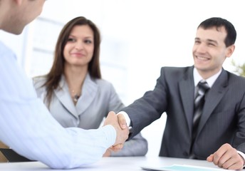 handshake business partners in the workplace