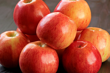 Ripe red apples on table close up
