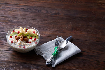 Breakfast still life with oatmeal porridge and fruits, top view, selective focus, shallow depth of field.