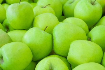 A pile of green apples as background, texture