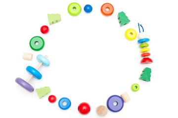 Bright wooden toys on a white background. Frame