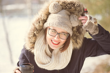 Smiling woman dressed for cold weather, woman with glasses