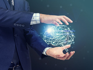 businessman holding digital image of brain