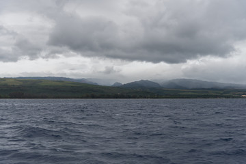 Kauai's west coast at dusk in winter viewed from a boat, Hawaii