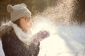 Young adult playing with snow