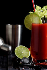 Bloody mary cocktail and ingredients: peper chili, lime, celery, ice and shaker. copy space