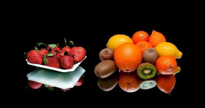 strawberries and other fruits on a black background